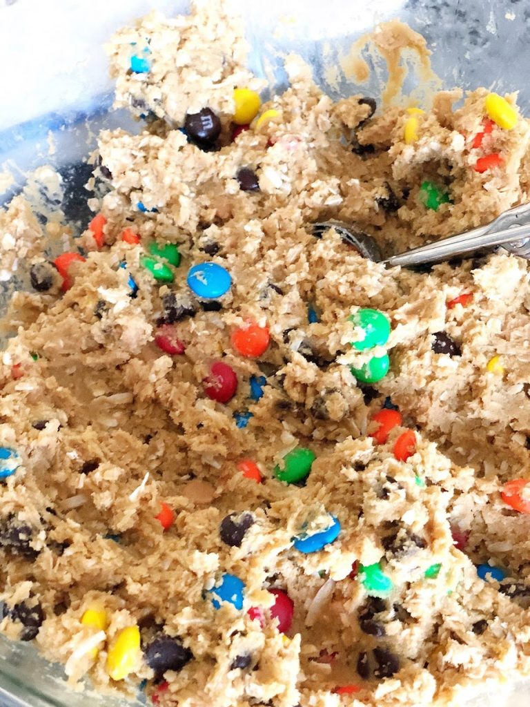 Try out this delicious Monster Cookie recipe that includes shredded coconut, chocolate chips, M&Ms, nuts, and peanut butter chips. They're an indulgent treat, sure to please your favorite cookie lover!