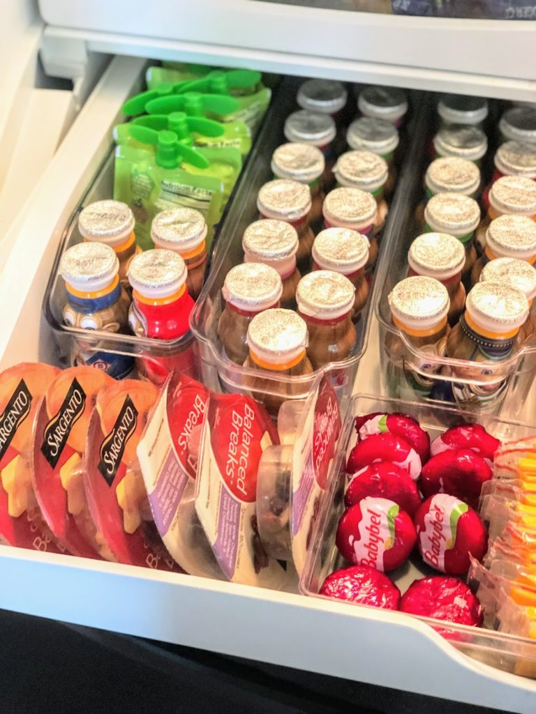 Have kids? This fridge snack drawer organization hack is the perfect solution for easy-access to healthy foods at kid-height! Using inexpensive refrigerator storage containers, you can create an organized space that makes it easy for all to see what snacking options are on hand. 