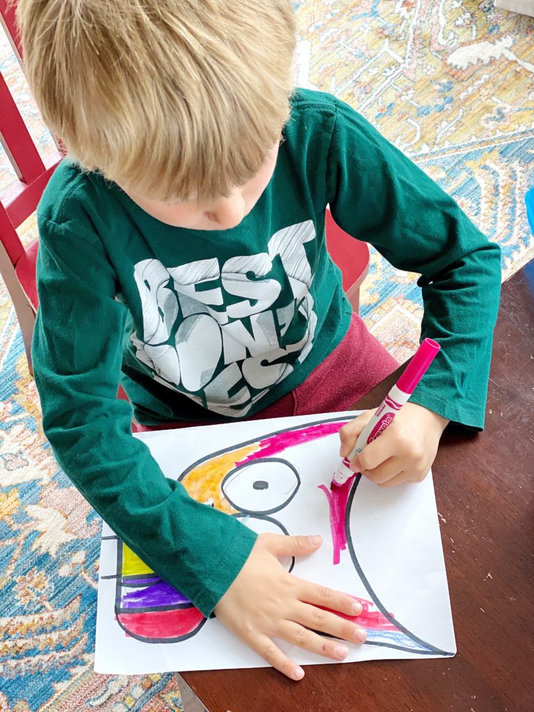 Coloring in an owl-themed directed drawing activity.